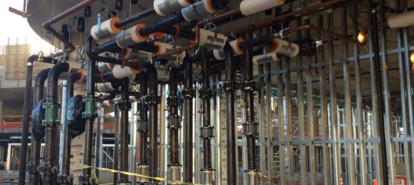 Red industrial pumps with insulated piping